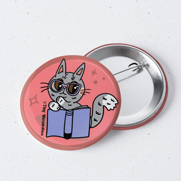 Based in Chicago by queer artist & designer Kayla Pekkala - Tiny Werewolves | Grey Book Cat 1" Mini Button Pin in | Shop to get your Metal Pinback Button with collections featuring retro-inspired designs infused with social commentary art, highlighting modern social & current events.