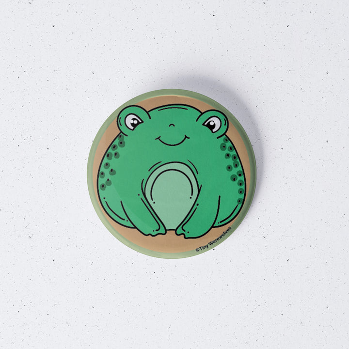 Based in Chicago by queer artist & designer Kayla Pekkala - Tiny Werewolves | Frog 1" Mini Button Pin in | Shop to get your Metal Pinback Button with collections featuring retro-inspired designs infused with social commentary art, highlighting modern social & current events.