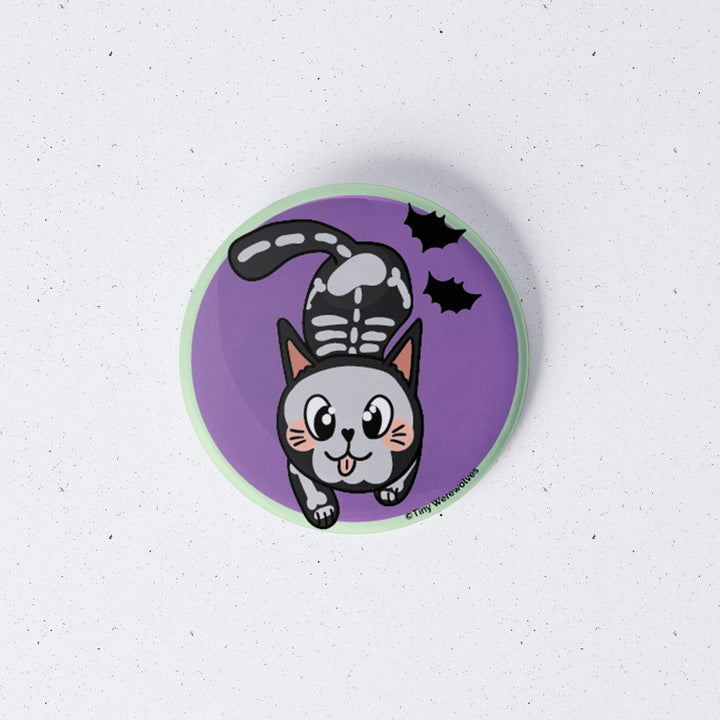 Based in Chicago by queer artist & designer Kayla Pekkala - Tiny Werewolves | SkeliCat Spooky 1" Mini Button Pin in | Shop to get your Metal Pinback Button with collections featuring retro-inspired designs infused with social commentary art, highlighting modern social & current events.