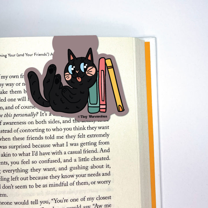 Based in Chicago by queer artist & designer Kayla Pekkala - Tiny Werewolves | Black Book Cat Laminated Magnetic Bookmark in | Shop to get your Magnetic Bookmark with collections featuring retro-inspired designs infused with social commentary art, highlighting modern social & current events.