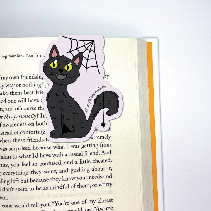 Based in Chicago by queer artist & designer Kayla Pekkala - Tiny Werewolves | Black Cat Spooky Laminated Magnetic Bookmark in | Shop to get your Magnetic Bookmark with collections featuring retro-inspired designs infused with social commentary art, highlighting modern social & current events.