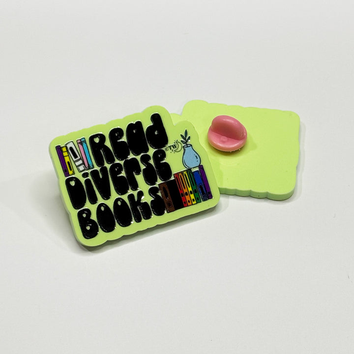 Based in Chicago by queer artist & designer Kayla Pekkala - Tiny Werewolves | Read Diverse Books Acrylic Pin in | Shop to get your Acrylic Pin with collections featuring retro-inspired designs infused with social commentary art, highlighting modern social & current events.