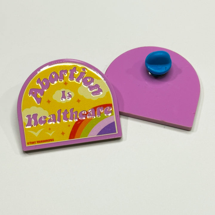 Based in Chicago by queer artist & designer Kayla Pekkala - Tiny Werewolves | Abortion is Healthcare Acrylic Pin in | Shop to get your Acrylic Pin with collections featuring retro-inspired designs infused with social commentary art, highlighting modern social & current events.