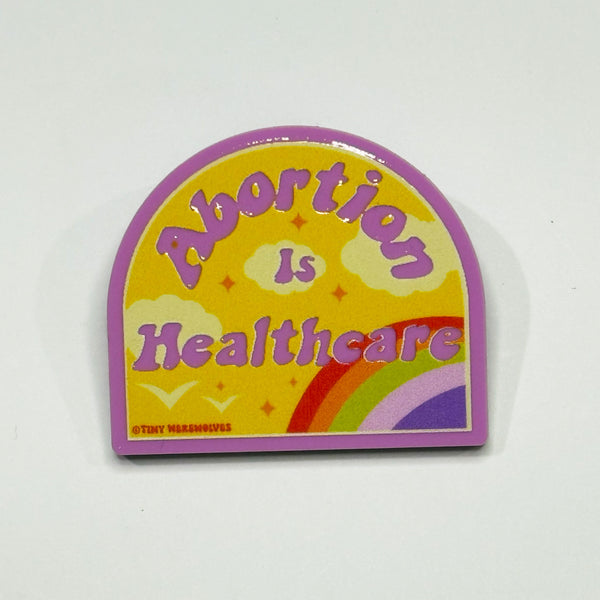 Based in Chicago by queer artist & designer Kayla Pekkala - Tiny Werewolves | Abortion is Healthcare Acrylic Pin in Bubblegum Pink | Shop to get your Acrylic Pin with collections featuring retro-inspired designs infused with social commentary art, highlighting modern social & current events.