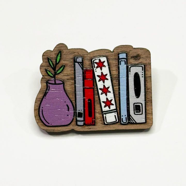 Based in Chicago by queer artist & designer Kayla Pekkala - Tiny Werewolves | Chicago Flag Bookshelf Wood Pin in Walnut | Shop to get your Wood Pin with collections featuring retro-inspired designs infused with social commentary art, highlighting modern social & current events.