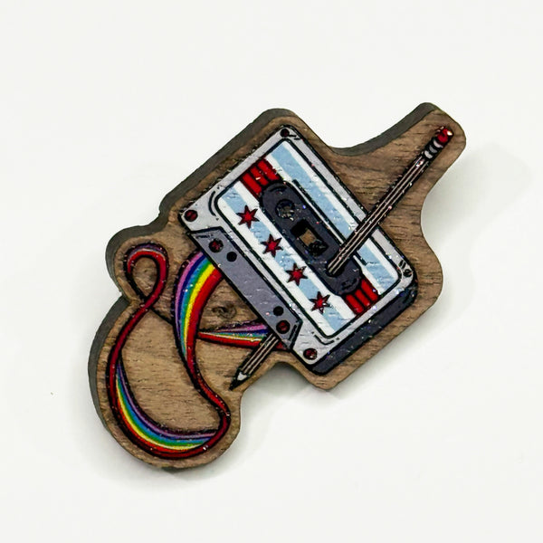 Based in Chicago by queer artist & designer Kayla Pekkala - Tiny Werewolves | Chicago Rewind Cassette Tape Wood Pin in Walnut | Shop to get your Wood Pin with collections featuring retro-inspired designs infused with social commentary art, highlighting modern social & current events.