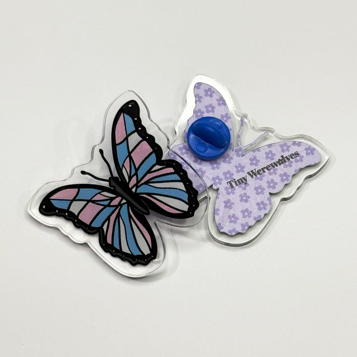 Based in Chicago by queer artist & designer Kayla Pekkala - Tiny Werewolves | Trans Pastel Subtle Queer Butterfly Acrylic Pin in | Shop to get your Acrylic Pin with collections featuring retro-inspired designs infused with social commentary art, highlighting modern social & current events.