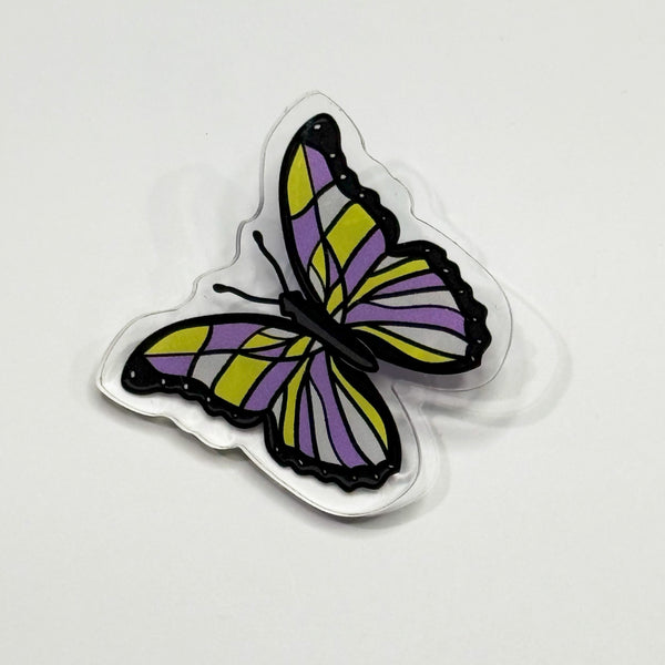 Based in Chicago by queer artist & designer Kayla Pekkala - Tiny Werewolves | Non-Binary Pastel Subtle Queer Butterfly Acrylic Pin in Clear | Shop to get your Acrylic Pin with collections featuring retro-inspired designs infused with social commentary art, highlighting modern social & current events.