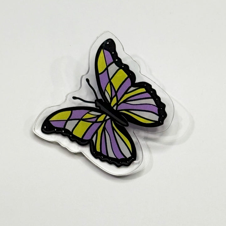 Based in Chicago by queer artist & designer Kayla Pekkala - Tiny Werewolves | Non-Binary Pastel Subtle Queer Butterfly Acrylic Pin in Clear | Shop to get your Acrylic Pin with collections featuring retro-inspired designs infused with social commentary art, highlighting modern social & current events.