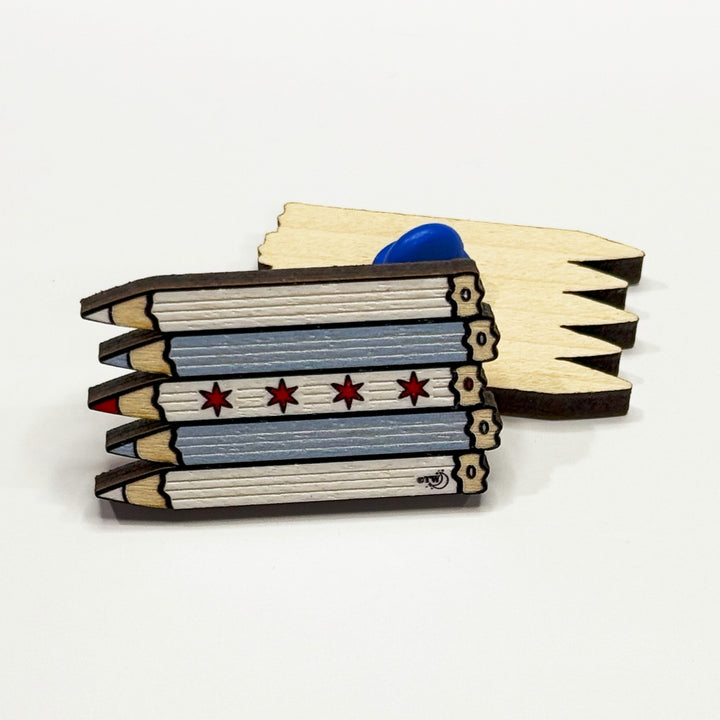 Based in Chicago by queer artist & designer Kayla Pekkala - Tiny Werewolves | Chicago Pencils Flag Wood Pin in | Shop to get your Wood Pin with collections featuring retro-inspired designs infused with social commentary art, highlighting modern social & current events.