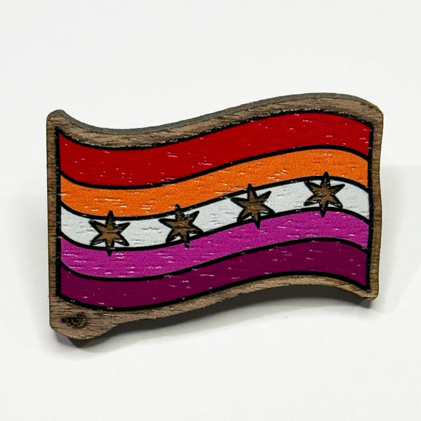 Based in Chicago by queer artist & designer Kayla Pekkala - Tiny Werewolves | Chicago Lesbian Pride Flag Wood Pin in Walnut | Shop to get your Wood Pin with collections featuring retro-inspired designs infused with social commentary art, highlighting modern social & current events.