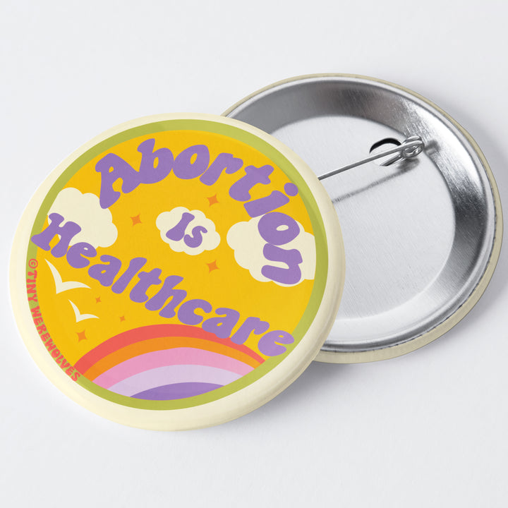 Based in Chicago by queer artist & designer Kayla Pekkala - Tiny Werewolves | Abortion Is Healthcare 1.75" Button Pin in | Shop to get your Metal Pinback Button with collections featuring retro-inspired designs infused with social commentary art, highlighting modern social & current events.