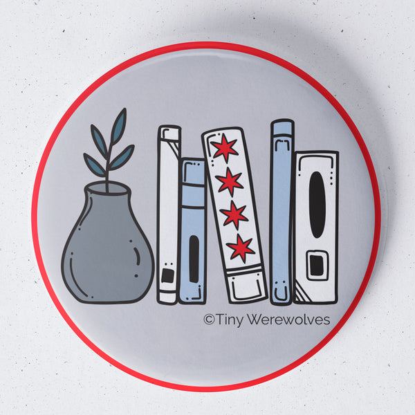 Based in Chicago by queer artist & designer Kayla Pekkala - Tiny Werewolves | Chicago Flag Bookshelf 1.75" Button Pin in | Shop to get your Metal Pinback Button with collections featuring retro-inspired designs infused with social commentary art, highlighting modern social & current events.