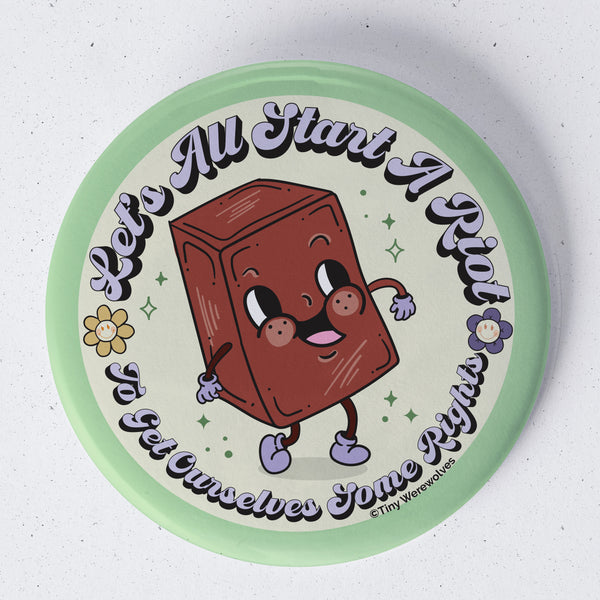 Based in Chicago by queer artist & designer Kayla Pekkala - Tiny Werewolves | Let's All Start A Riot 1.75" Button Pin in | Shop to get your Metal Pinback Button with collections featuring retro-inspired designs infused with social commentary art, highlighting modern social & current events.