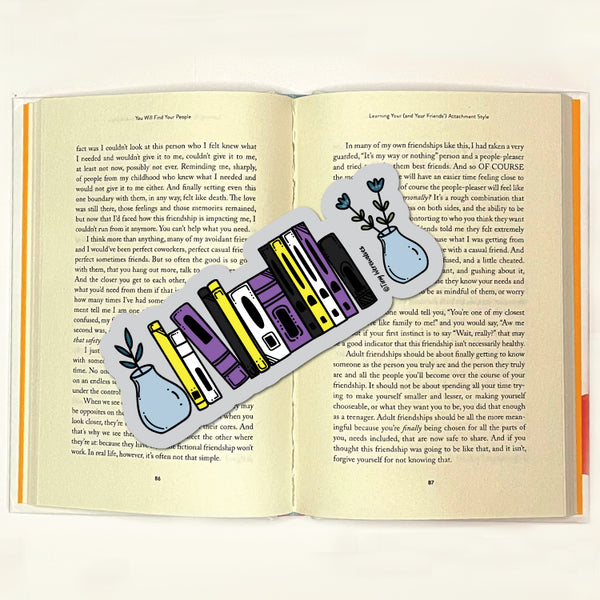 Based in Chicago by queer artist & designer Kayla Pekkala - Tiny Werewolves | Non-Binary Bookshelf Pride Laminated Printed Bookmark in | Shop to get your Laminated Bookmark with collections featuring retro-inspired designs infused with social commentary art, highlighting modern social & current events.
