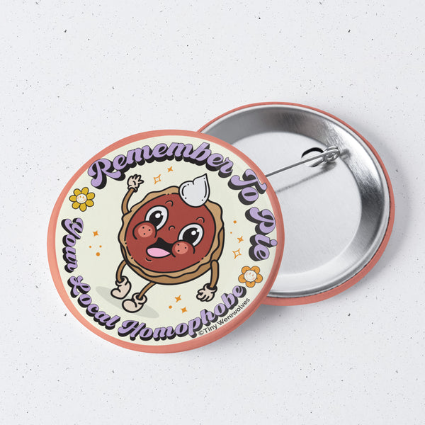 Based in Chicago by queer artist & designer Kayla Pekkala - Tiny Werewolves | Pie Your Local Homophobe 1" Mini Button Pin in | Shop to get your Metal Pinback Button with collections featuring retro-inspired designs infused with social commentary art, highlighting modern social & current events.