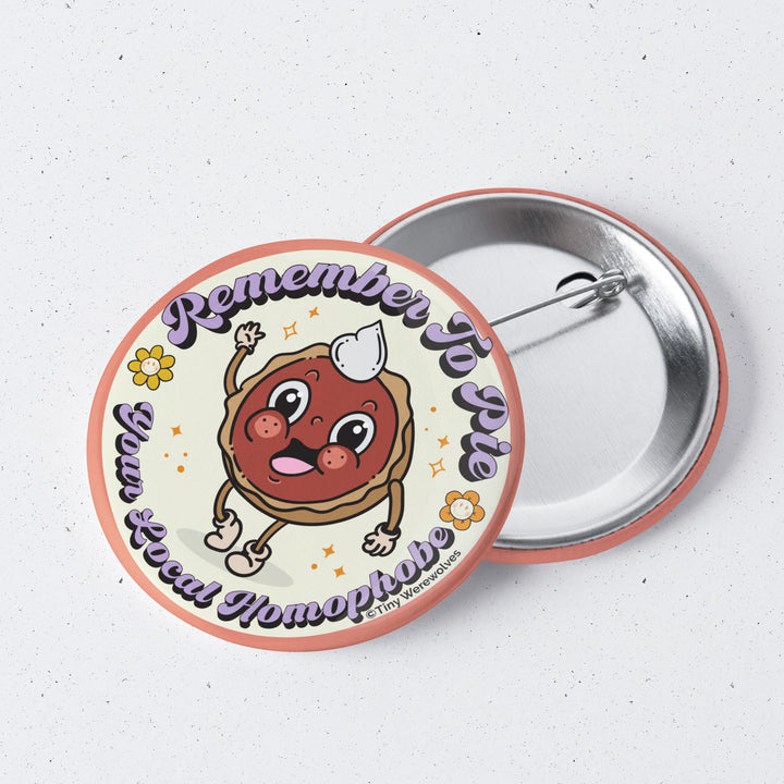 Based in Chicago by queer artist & designer Kayla Pekkala - Tiny Werewolves | Pie Your Local Homophobe 1" Mini Button Pin in | Shop to get your Metal Pinback Button with collections featuring retro-inspired designs infused with social commentary art, highlighting modern social & current events.