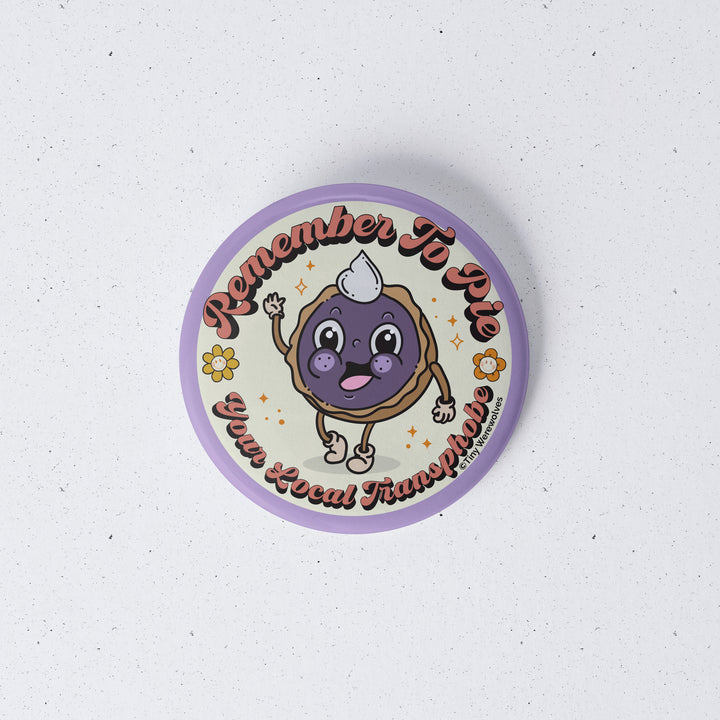 Based in Chicago by queer artist & designer Kayla Pekkala - Tiny Werewolves | Pie Your Local Transphobe 1" Mini Button Pin in | Shop to get your Metal Pinback Button with collections featuring retro-inspired designs infused with social commentary art, highlighting modern social & current events.