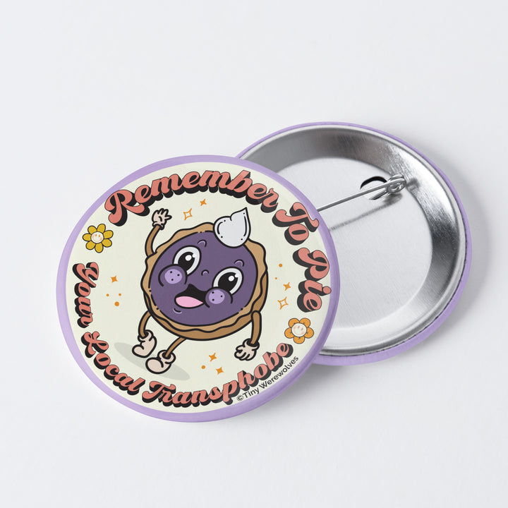 Based in Chicago by queer artist & designer Kayla Pekkala - Tiny Werewolves | Pie Your Local Transphobe 1" Mini Button Pin in | Shop to get your Metal Pinback Button with collections featuring retro-inspired designs infused with social commentary art, highlighting modern social & current events.
