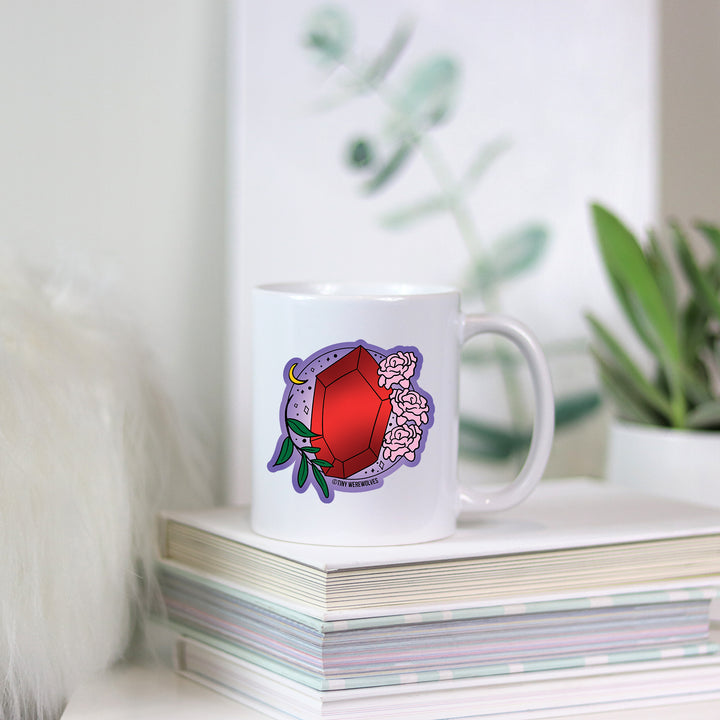 Based in Chicago by queer artist & designer Kayla Pekkala - Tiny Werewolves | January Crystal & Flower Birthstone Mug in | Shop to get your Mug with collections featuring retro-inspired designs infused with social commentary art, highlighting modern social & current events.