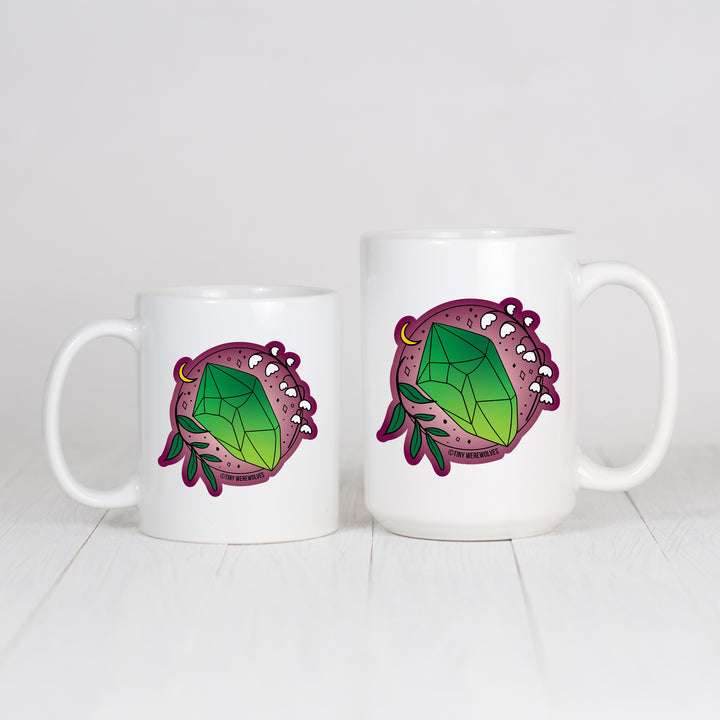 Based in Chicago by queer artist & designer Kayla Pekkala - Tiny Werewolves | May Crystal & Flower Birthstone Mug in | Shop to get your Mug with collections featuring retro-inspired designs infused with social commentary art, highlighting modern social & current events.