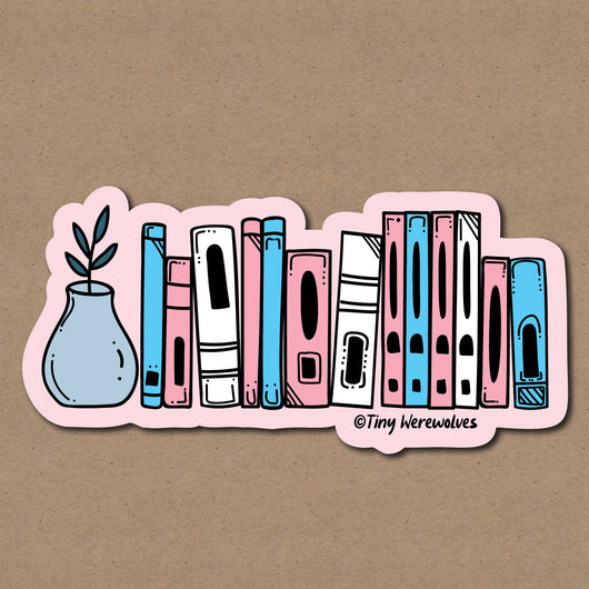 Based in Chicago by queer artist & designer Kayla Pekkala - Tiny Werewolves | Transgender Bookshelf Pride Sticker in 5" Sticker | Shop to get your Sticker with collections featuring retro-inspired designs infused with social commentary art, highlighting modern social & current events.