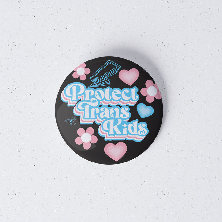 Based in Chicago by queer artist & designer Kayla Pekkala - Tiny Werewolves | Retro Protect Trans Kids 1" Mini Button Pin in | Shop to get your Metal Pinback Button with collections featuring retro-inspired designs infused with social commentary art, highlighting modern social & current events.