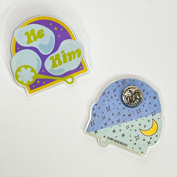Based in Chicago by queer artist & designer Kayla Pekkala - Tiny Werewolves | He / Him Pronouns Bubble Acrylic Pin in Clear | Shop to get your Acrylic Pin with collections featuring retro-inspired designs infused with social commentary art, highlighting modern social & current events.