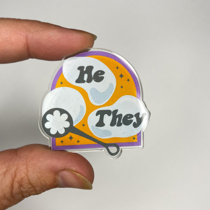 Based in Chicago by queer artist & designer Kayla Pekkala - Tiny Werewolves | He / They Pronouns Bubble Acrylic Pin in | Shop to get your Acrylic Pin with collections featuring retro-inspired designs infused with social commentary art, highlighting modern social & current events.
